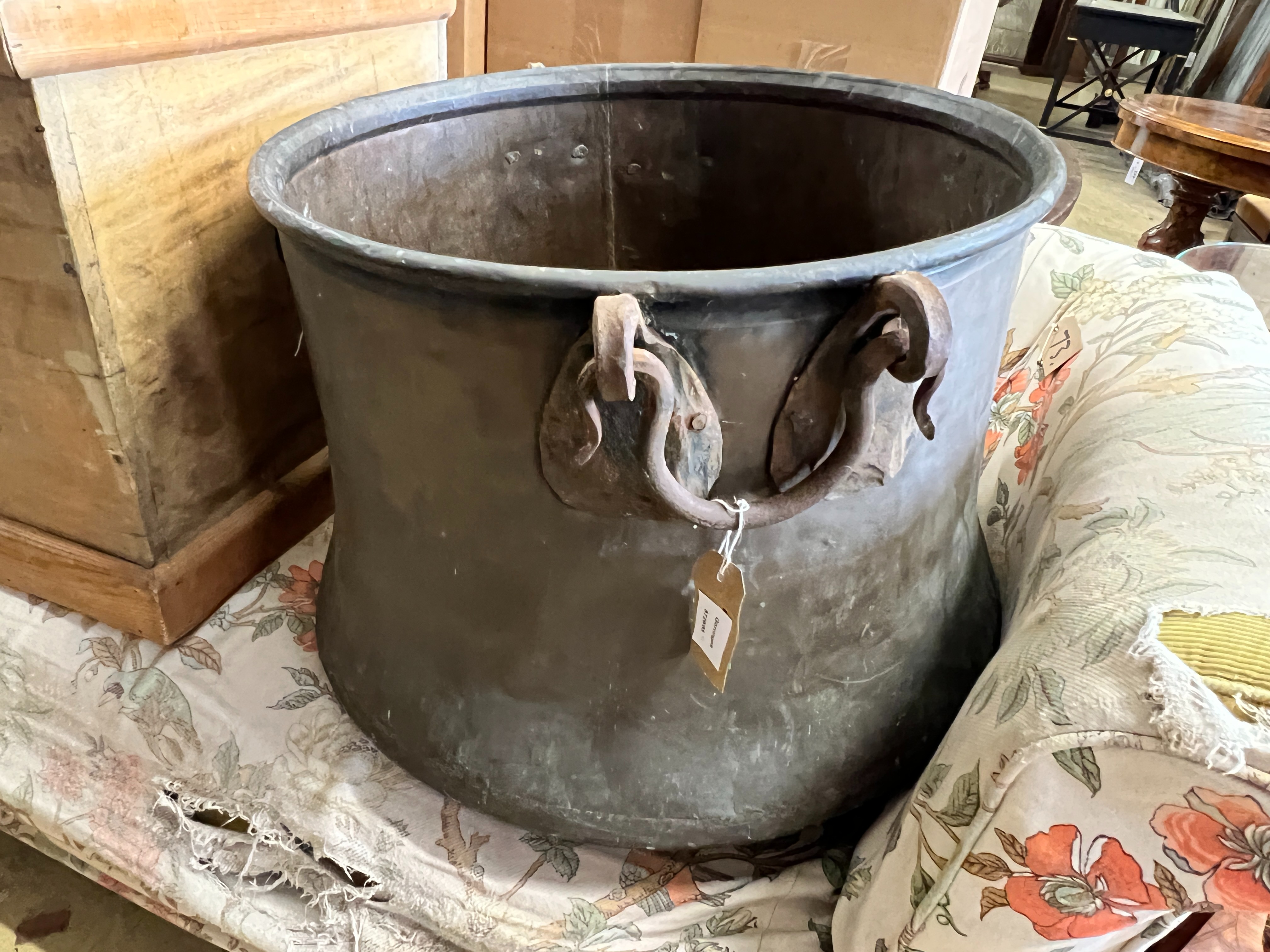 A Victorian circular copper cauldron with wrought iron handles, diameter 56cm, height 42cm